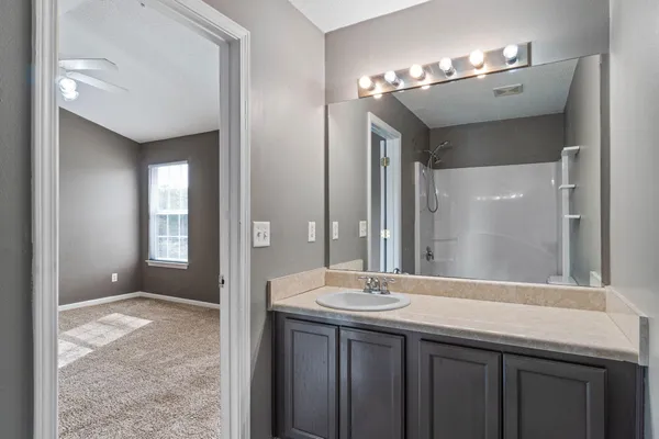 a bathroom with a double vanity sink and a mirror