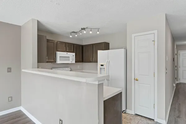 a kitchen with refrigerator and cabinets