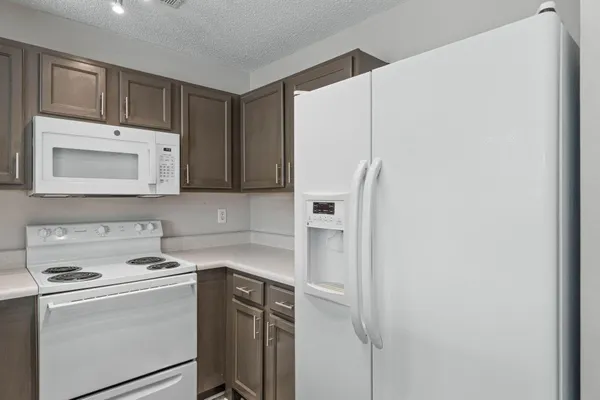a utility room with cabinets washer and dryer