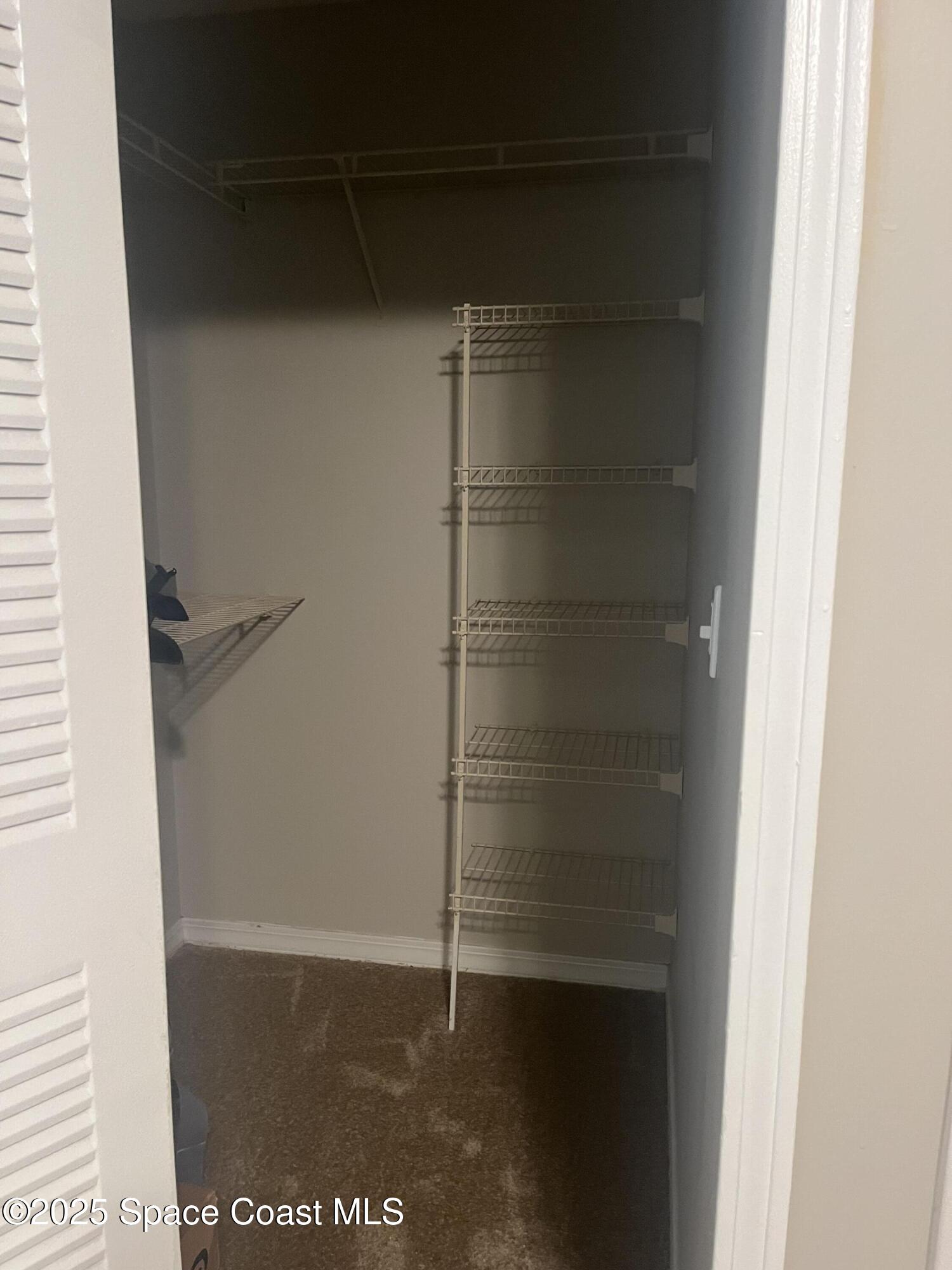 7667 North Wickham Road, Unit 1118 Melbourne, FL 32940 - Photo 11 of 17 a bathroom with a glass door