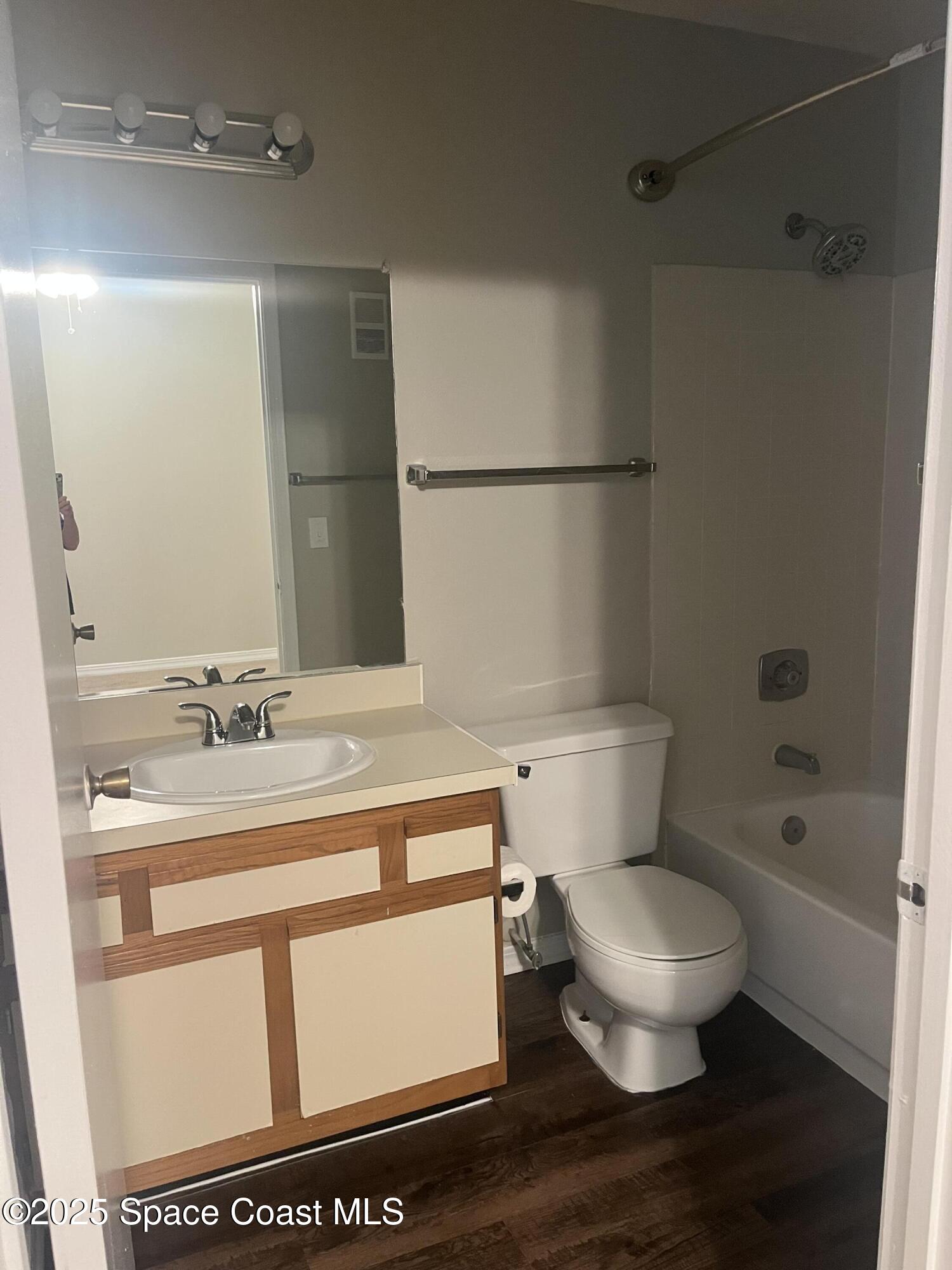 7667 North Wickham Road, Unit 1118 Melbourne, FL 32940 - Photo 12 of 17 a bathroom with a sink a toilet and shower