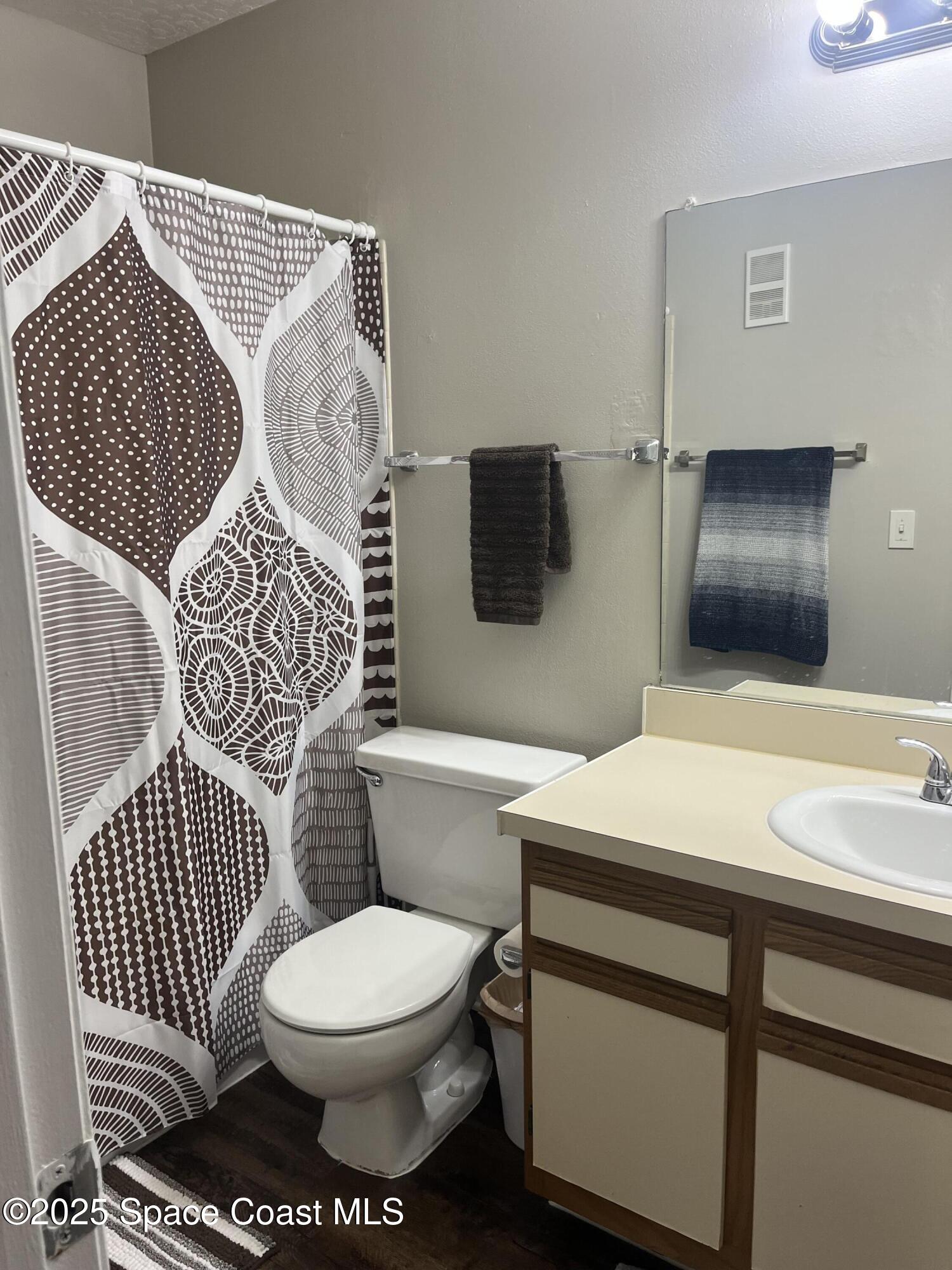 7667 North Wickham Road, Unit 1118 Melbourne, FL 32940 - Photo 15 of 17 a bathroom with a sink toilet and shower