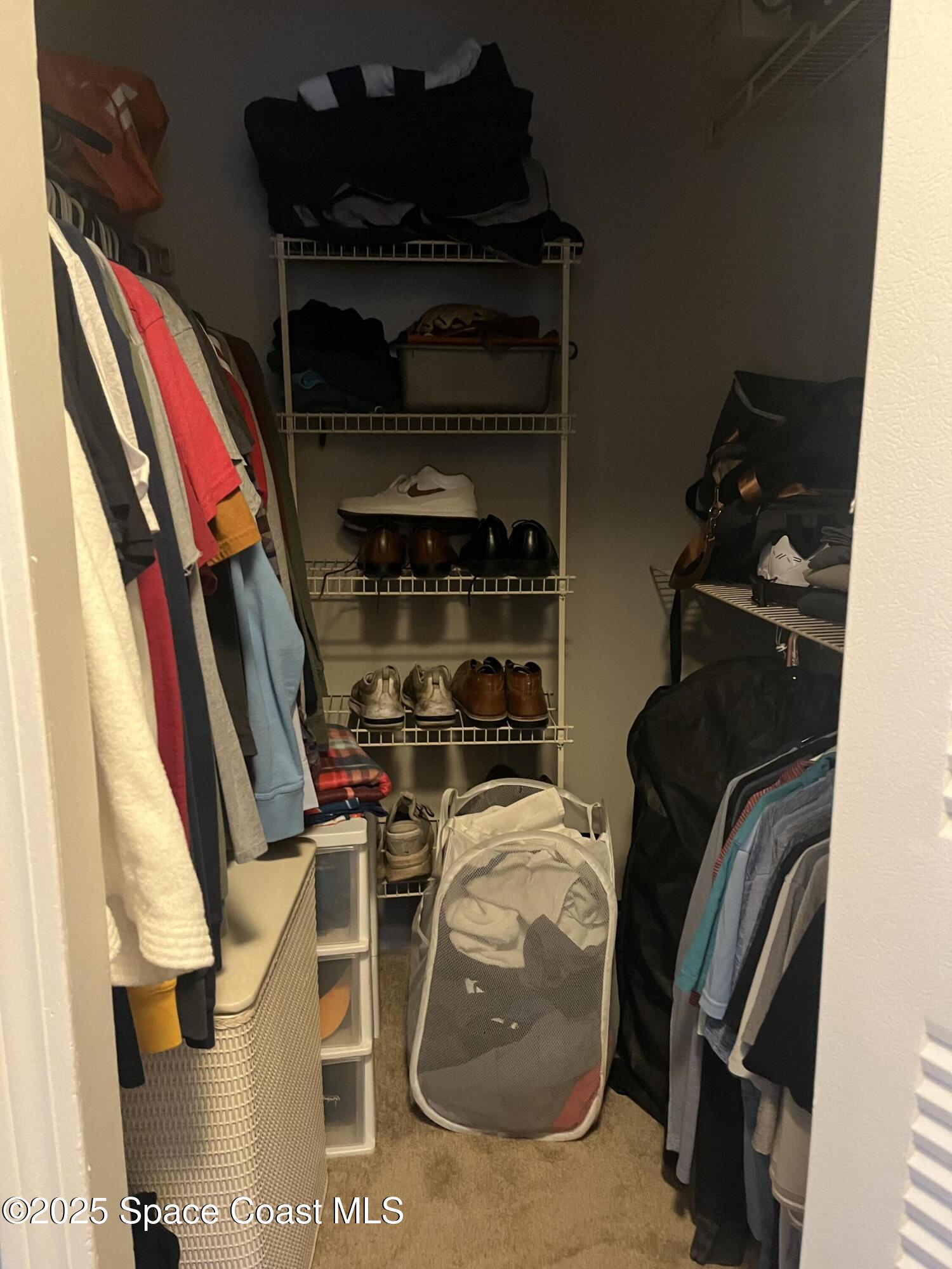 7667 North Wickham Road, Unit 1118 Melbourne, FL 32940 - Photo 16 of 17 a view of walk in closet with clothes and shoes
