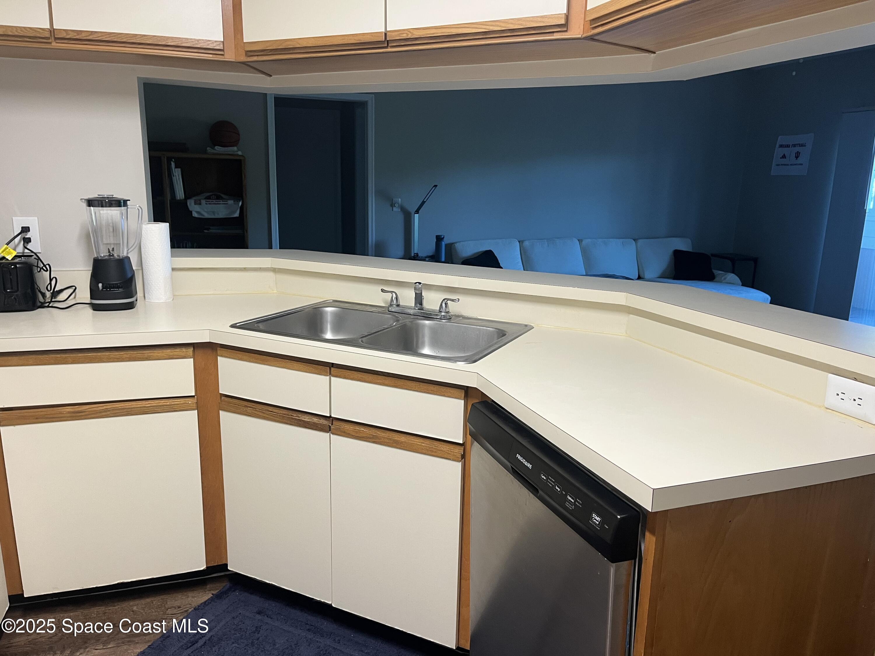 7667 North Wickham Road, Unit 1118 Melbourne, FL 32940 - Photo 3 of 17 a kitchen with a sink and cabinets