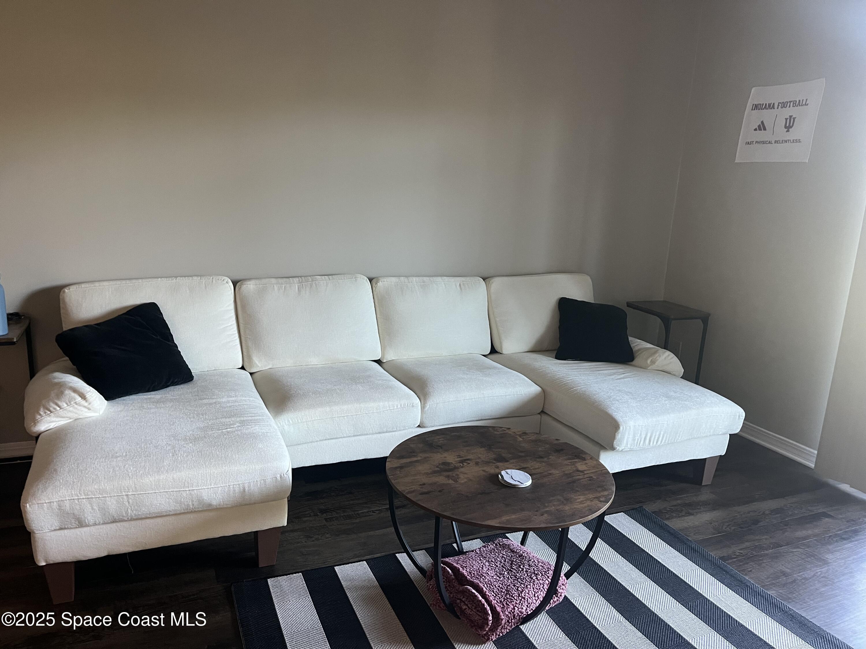 7667 North Wickham Road, Unit 1118 Melbourne, FL 32940 - Photo 6 of 17 a living room with furniture and a rug