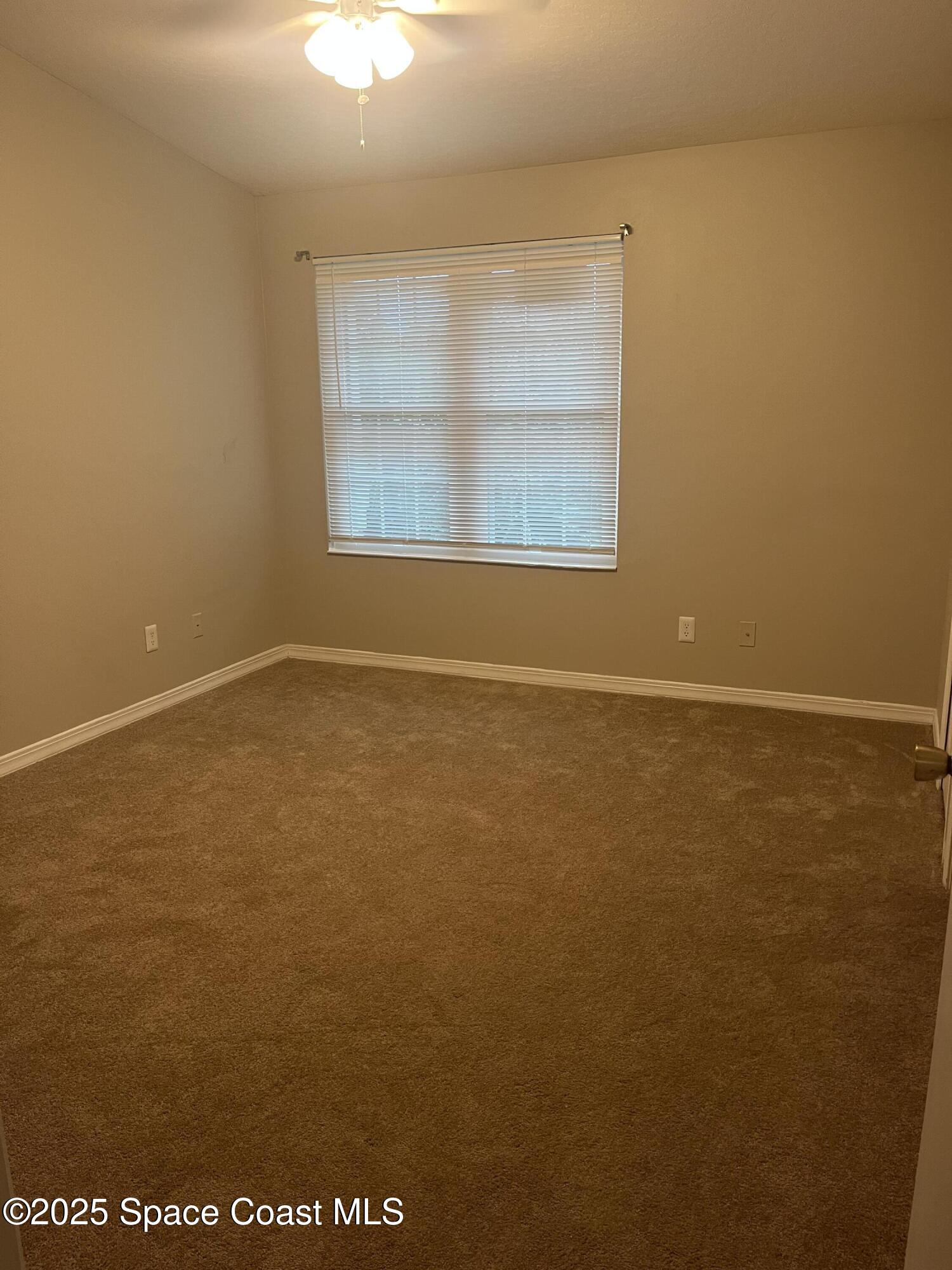 7667 North Wickham Road, Unit 1118 Melbourne, FL 32940 - Photo 10 of 17 an empty room with a window