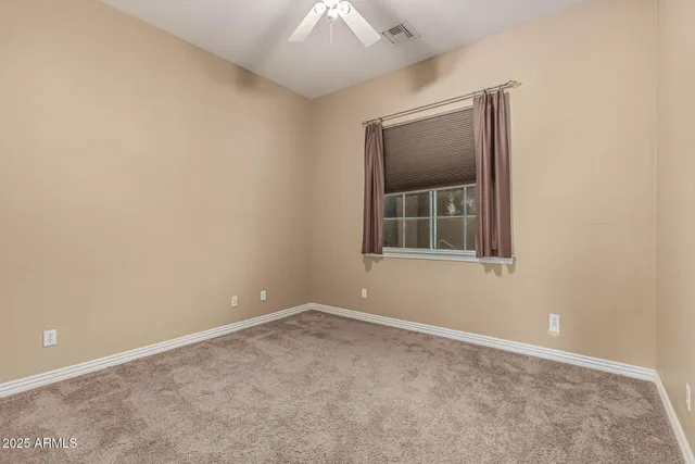 an empty room with a window and closet