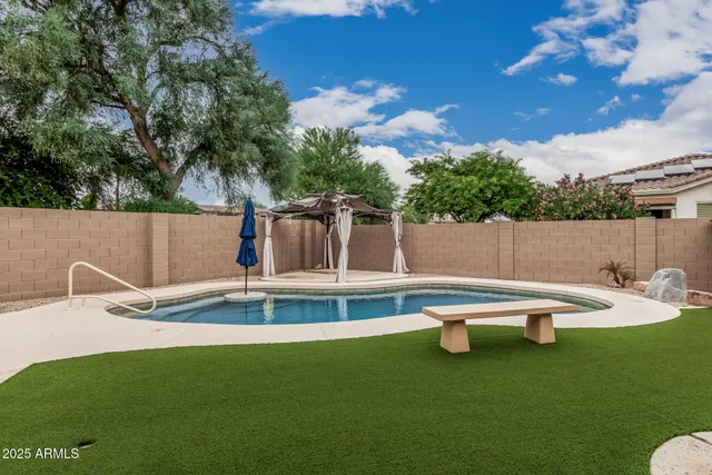 a view of a wooden deck with chairs and fire pit