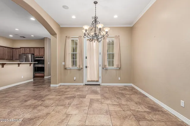 a view of a kitchen with a sink and refrigerator