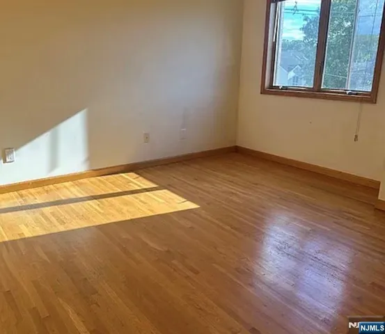 a view of a room with wooden floor and windows