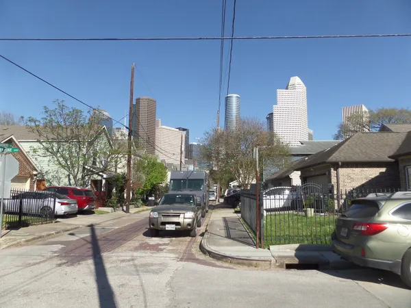 a city street with cars parked in front of it