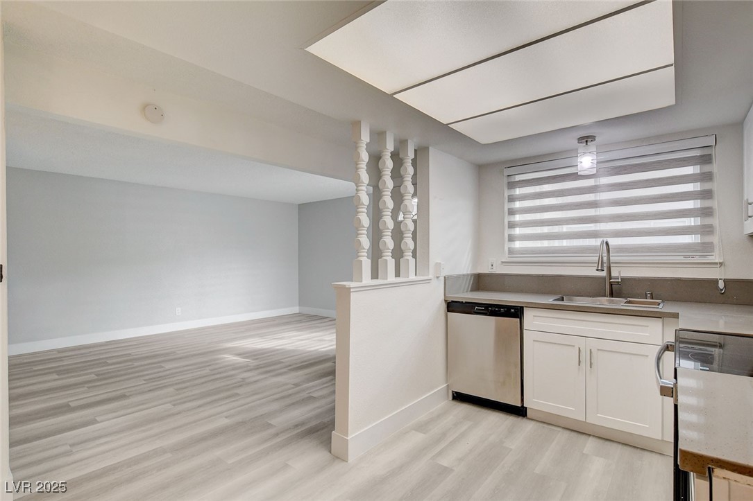 579 Roxella Lane, Unit B Las Vegas, NV 89110 - Photo 1 of 28 Kitchen with stainless steel appliances, light wood finished floors, and white cabinets