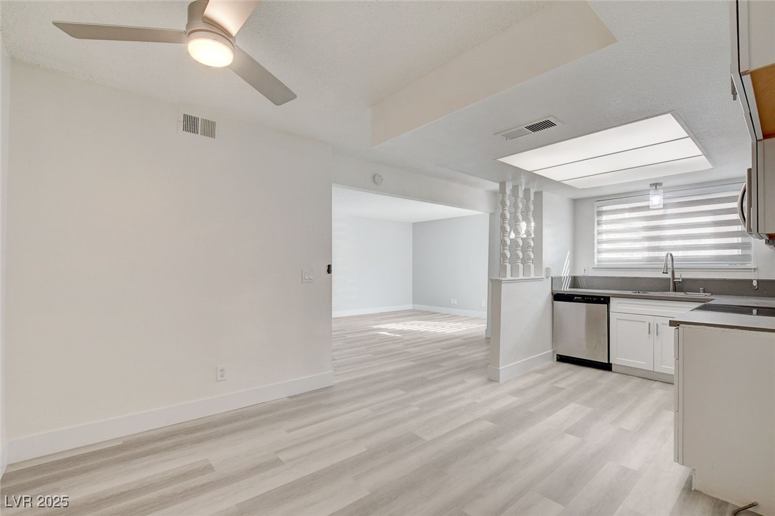 579 Roxella Lane, Unit B Las Vegas, NV 89110 - Photo 28 of 28 Kitchen with light wood-style flooring, white cabinetry, stainless steel appliances, and open floor plan