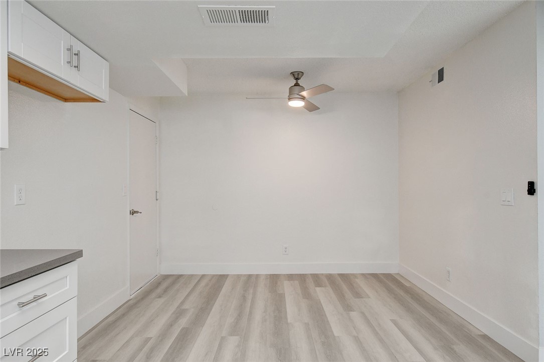 579 Roxella Lane, Unit B Las Vegas, NV 89110 - Photo 12 of 28 Unfurnished dining area featuring light wood finished floors and ceiling fan
