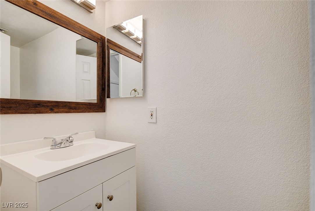 579 Roxella Lane, Unit B Las Vegas, NV 89110 - Photo 16 of 28 Bathroom featuring vanity and a textured wall