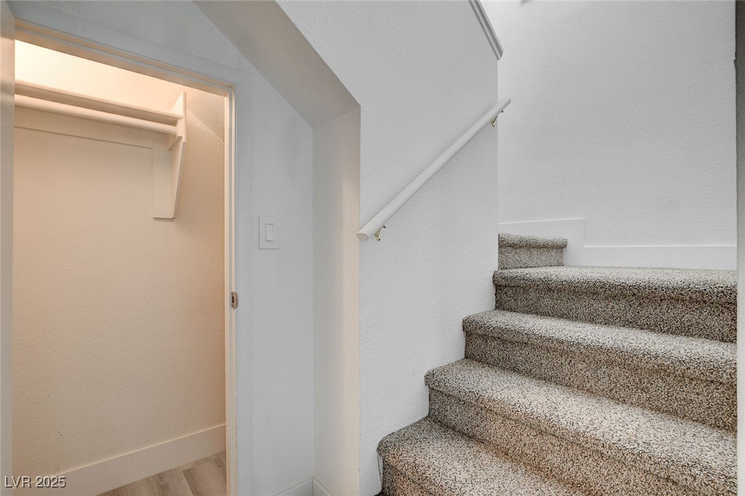 579 Roxella Lane, Unit B Las Vegas, NV 89110 - Photo 17 of 28 Staircase with baseboards and wood finished floors