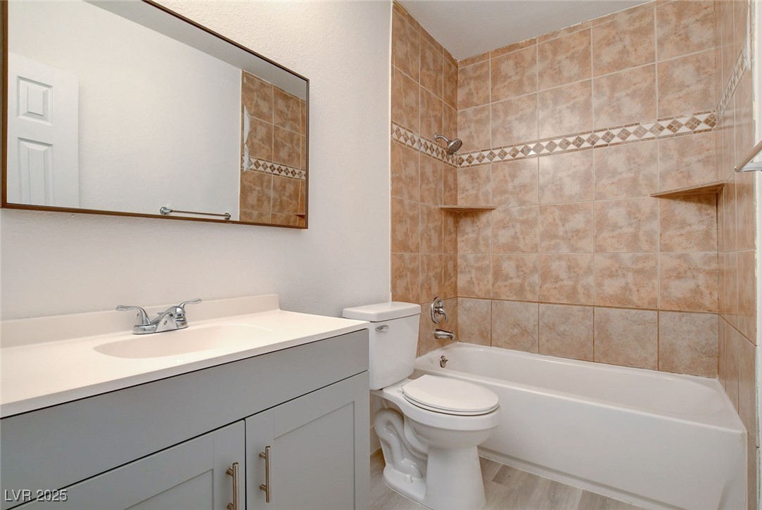 579 Roxella Lane, Unit B Las Vegas, NV 89110 - Photo 25 of 28 Full bath with vanity, shower combination, and light wood-style floors