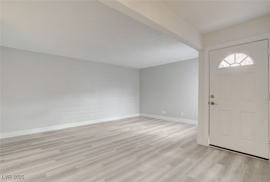 579 Roxella Lane, Unit B Las Vegas, NV 89110 - Photo 5 of 28 Foyer featuring light wood-type flooring and baseboards