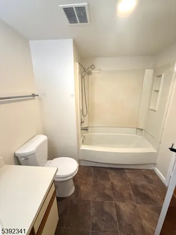 a bathroom with a toilet and a tub