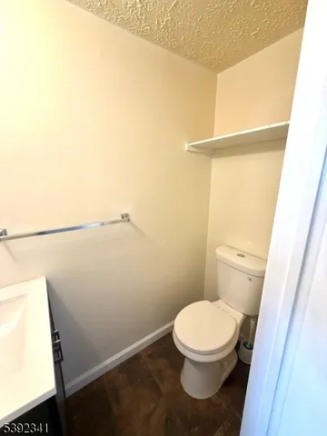 a white toilet sitting next to a shower