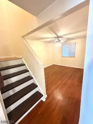 a view of a room with wooden floor and white walls
