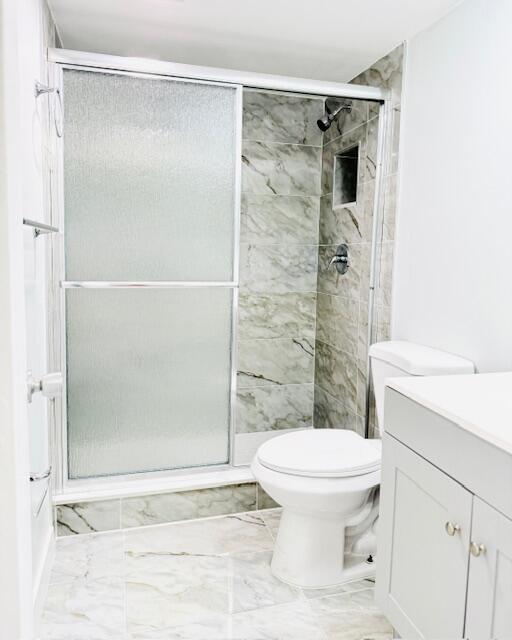 3051 North Course Drive, Unit 209 Pompano Beach, FL 33069 - Photo 11 of 17 a bathroom with a toilet and a shower