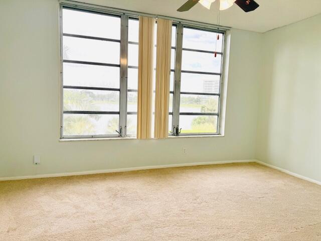 3051 North Course Drive, Unit 209 Pompano Beach, FL 33069 - Photo 12 of 17 an empty room with a window