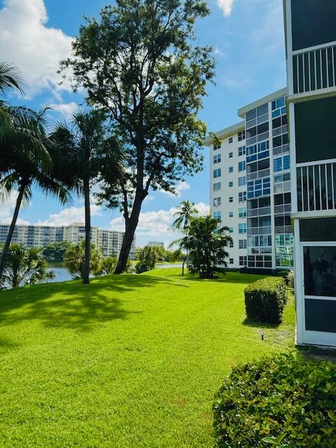 3051 North Course Drive, Unit 209 Pompano Beach, FL 33069 - Photo 5 of 17 a view of a garden with plants and large trees