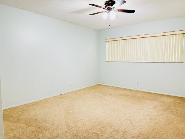 3051 North Course Drive, Unit 209 Pompano Beach, FL 33069 - Photo 7 of 17 an empty room with a window and a fan
