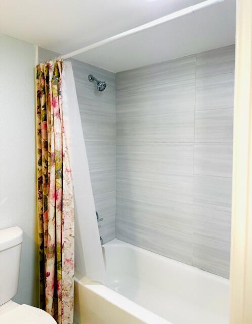 3051 North Course Drive, Unit 209 Pompano Beach, FL 33069 - Photo 8 of 17 a bathroom with a bathtub and shower