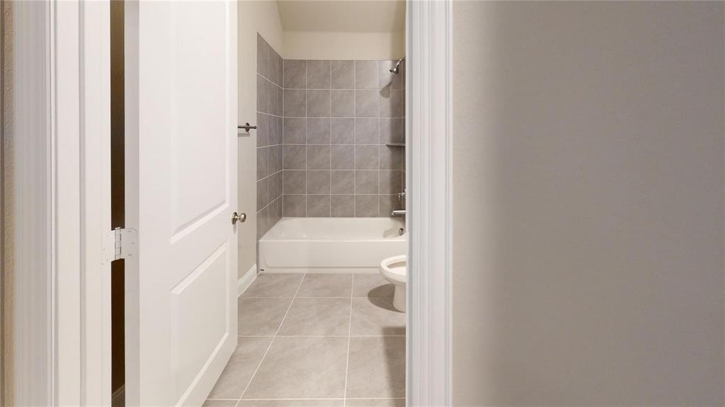 1420 Elizabeth Street Anna, TX 75409 - Photo 14 of 18 a bathroom with a bathtub and a shower