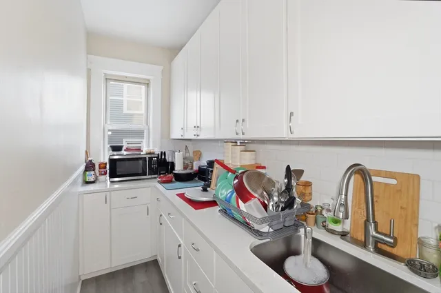 a kitchen with stainless steel appliances granite countertop a sink and cabinets