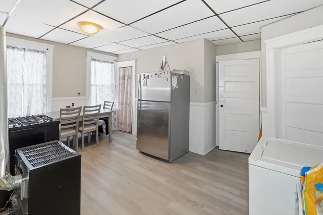 a kitchen with stainless steel appliances granite countertop a refrigerator and a stove top oven