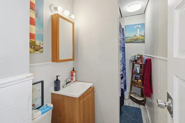 a bathroom with a sink mirror and vanity