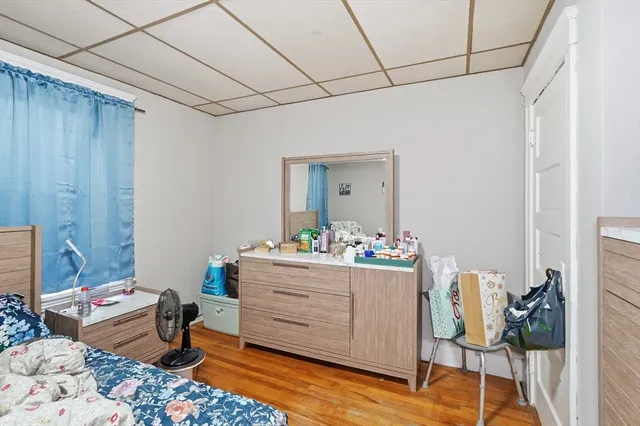 a bed room with a bed and a dresser