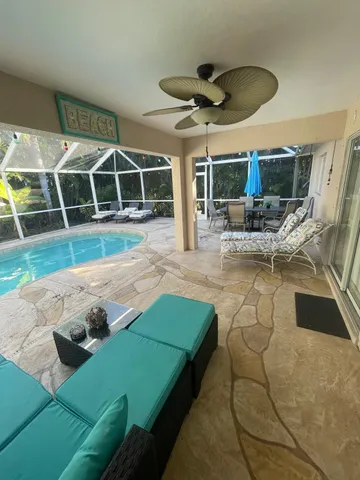 a bedroom with a bed a chandelier and dresser