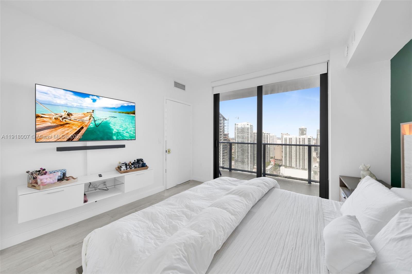 45 Southwest 9th Street, Unit 3909 Miami, FL 33130 - Photo 12 of 23 a bedroom with a bed and a flat screen tv