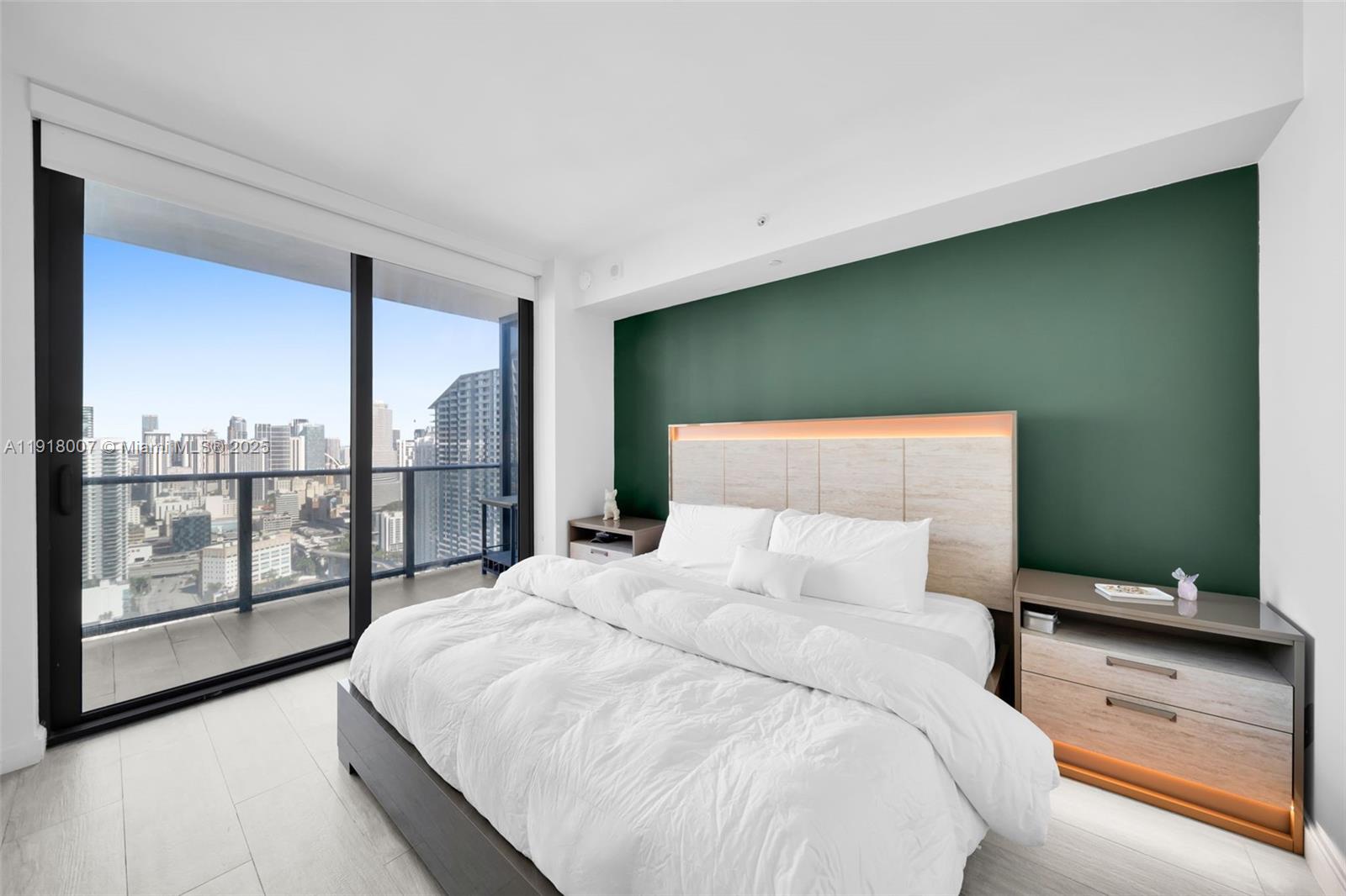 45 Southwest 9th Street, Unit 3909 Miami, FL 33130 - Photo 14 of 23 a bedroom with a large bed and a large window