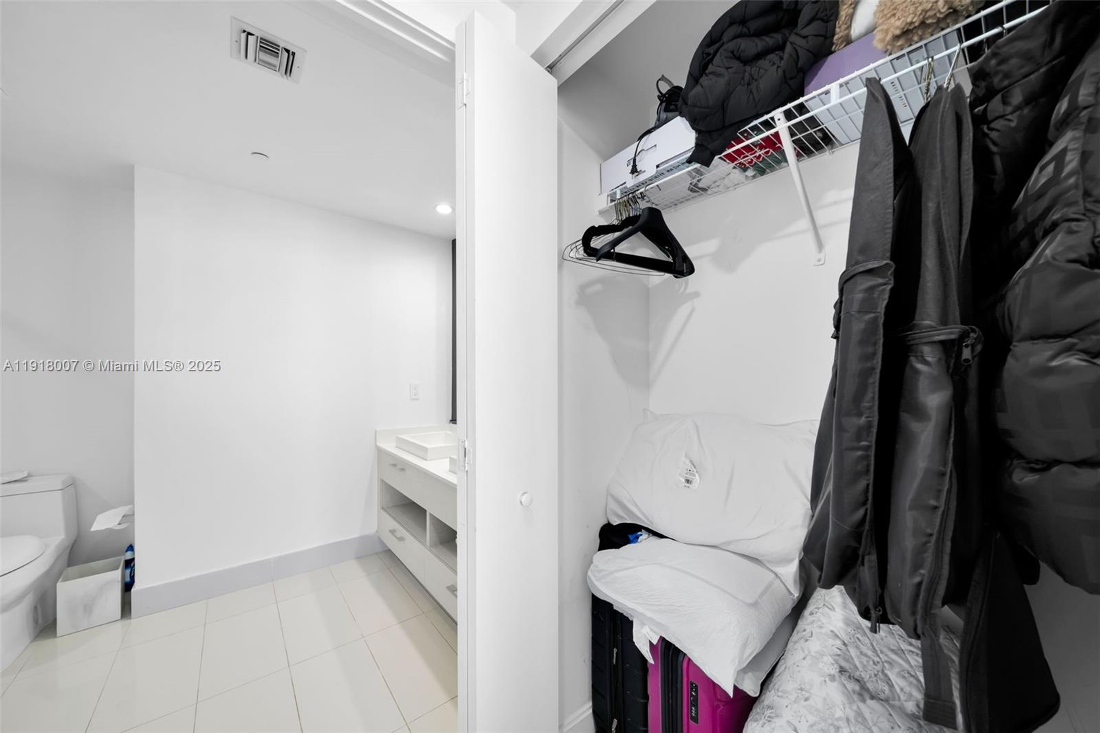 45 Southwest 9th Street, Unit 3909 Miami, FL 33130 - Photo 18 of 23 a view of walk in closet with clothes and shoes