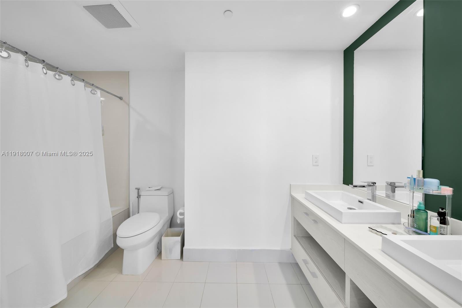 45 Southwest 9th Street, Unit 3909 Miami, FL 33130 - Photo 19 of 23 a bathroom with a sink a toilet and a mirror