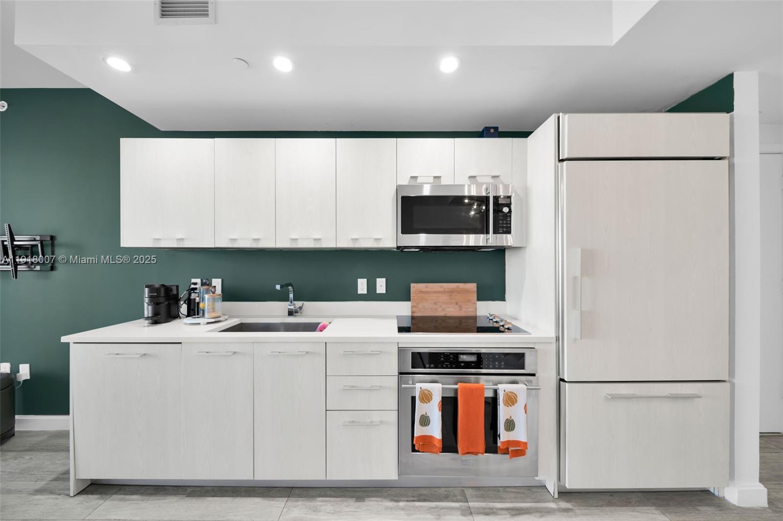 45 Southwest 9th Street, Unit 3909 Miami, FL 33130 - Photo 3 of 23 a kitchen with a refrigerator sink and stove top oven