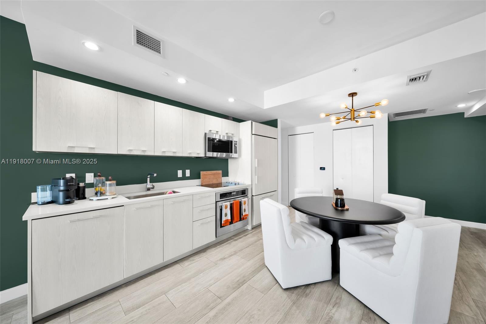 45 Southwest 9th Street, Unit 3909 Miami, FL 33130 - Photo 4 of 23 a kitchen that has a sink and a stove with white countertops