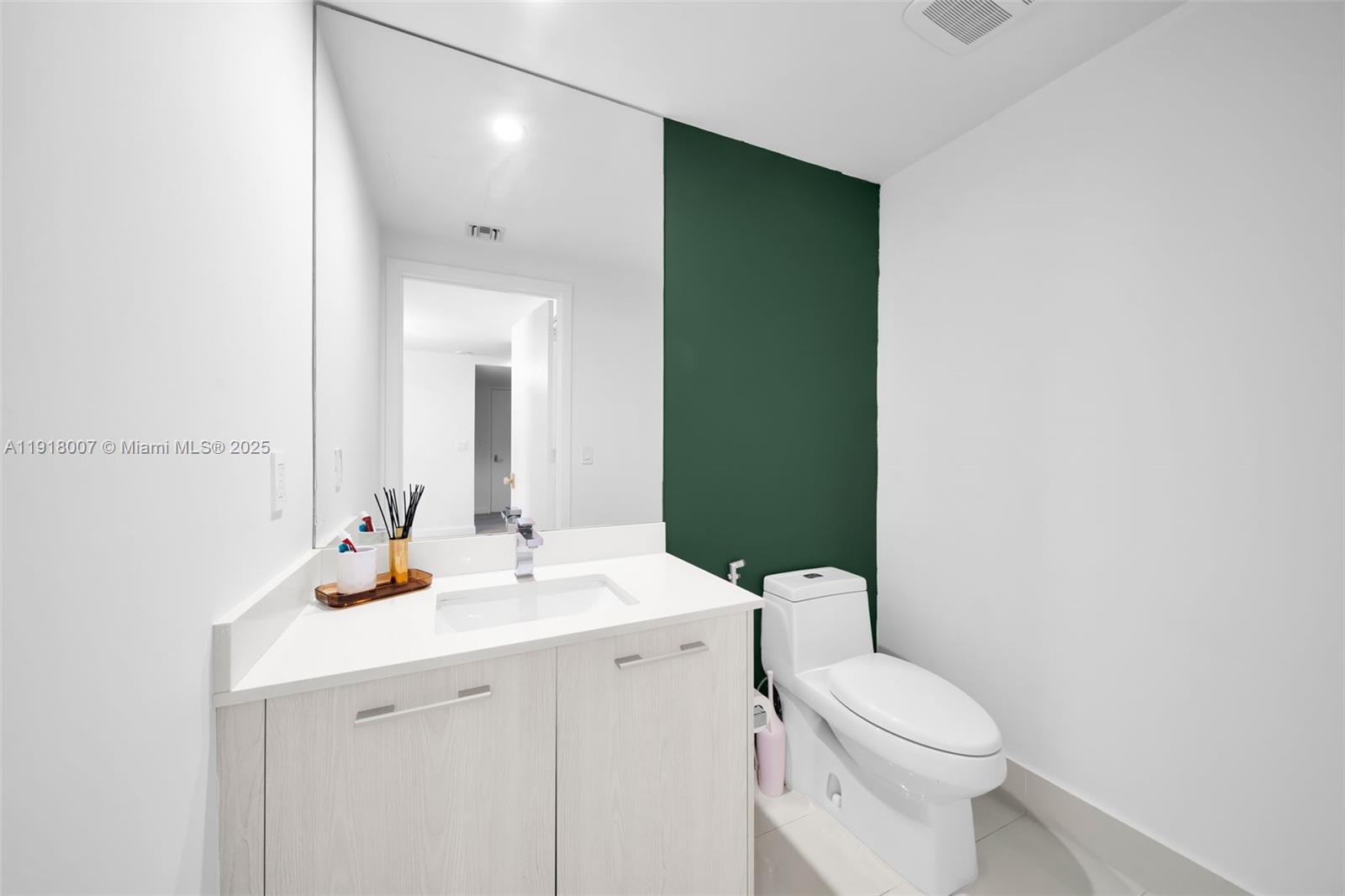 45 Southwest 9th Street, Unit 3909 Miami, FL 33130 - Photo 7 of 23 a bathroom with a toilet a sink and mirror