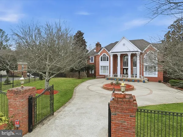 a front view of a house with swimming pool and sitting area