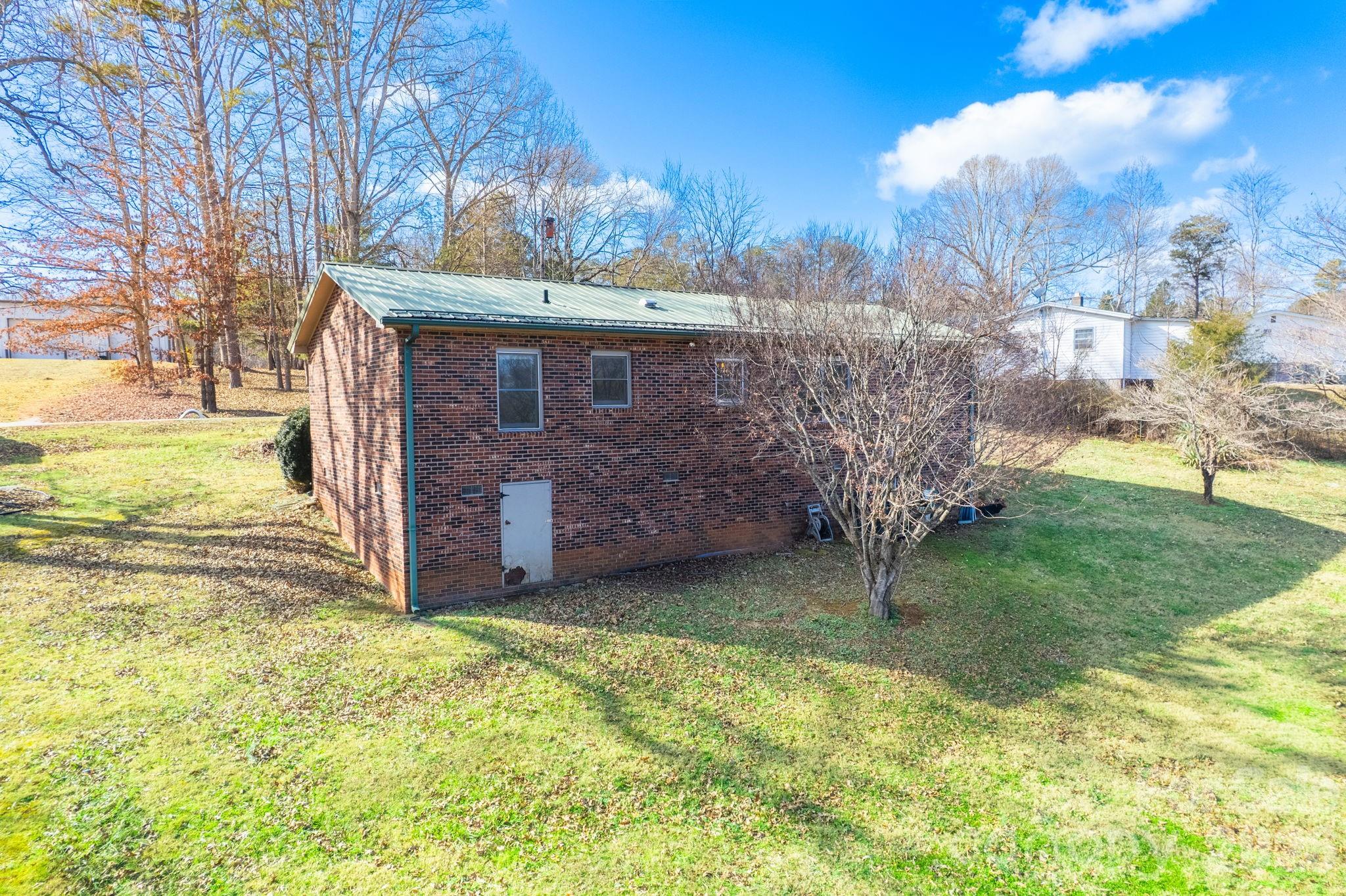 225 Baxter Street Morganton, NC 28655 - Photo 17 of 22 a view of a backyard with large trees