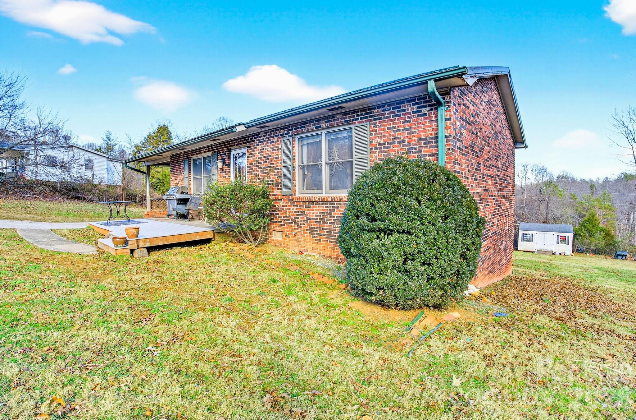 225 Baxter Street Morganton, NC 28655 - Photo 20 of 22 a front view of a house with garden