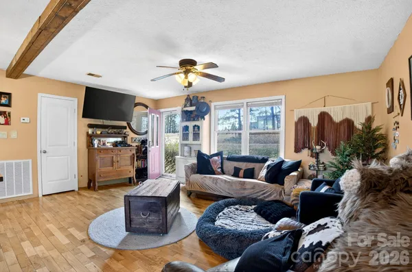 a living room with furniture fireplace and a large window