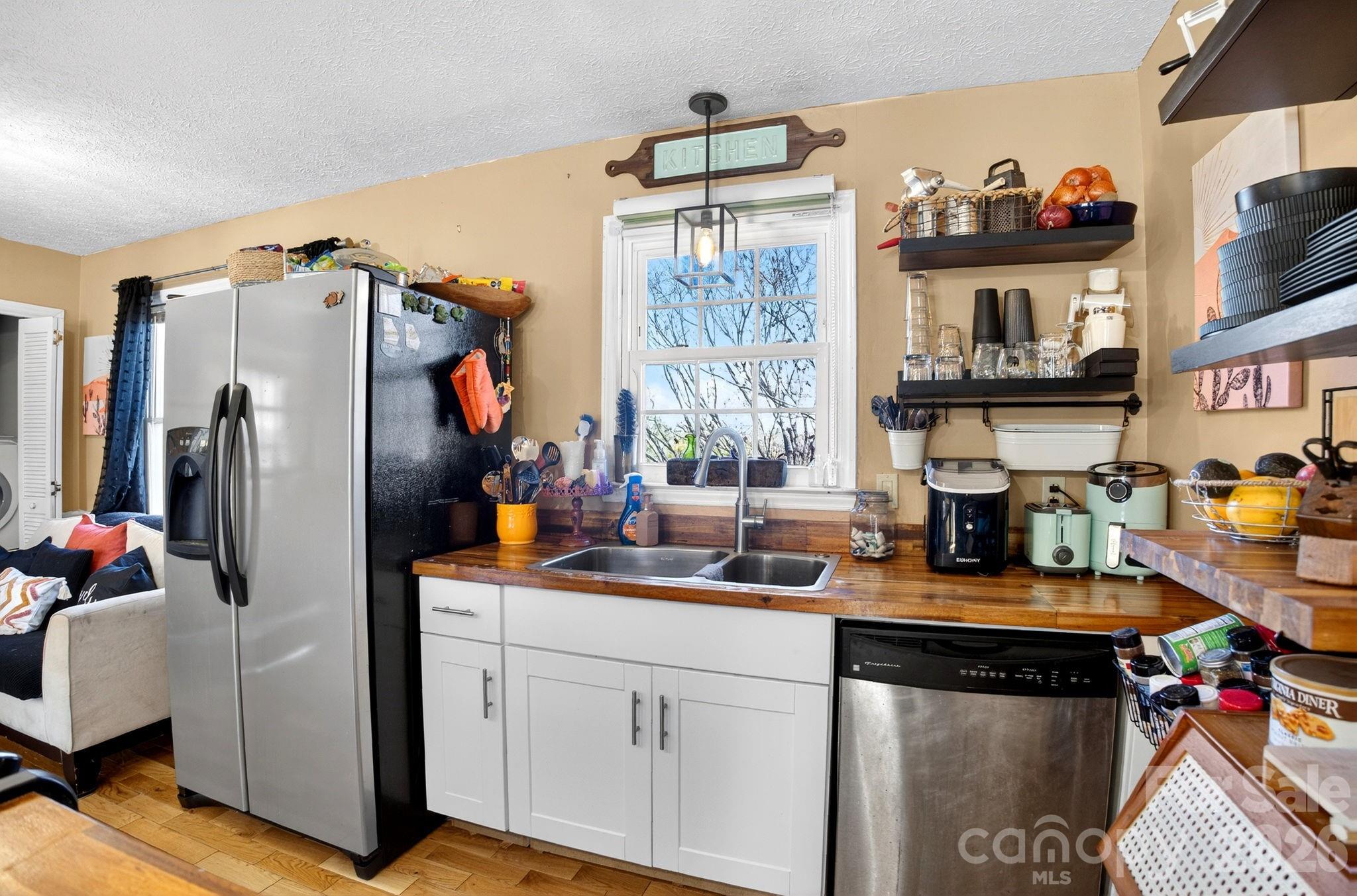 225 Baxter Street Morganton, NC 28655 - Photo 6 of 22 a kitchen with stainless steel appliances a sink cabinets and a window