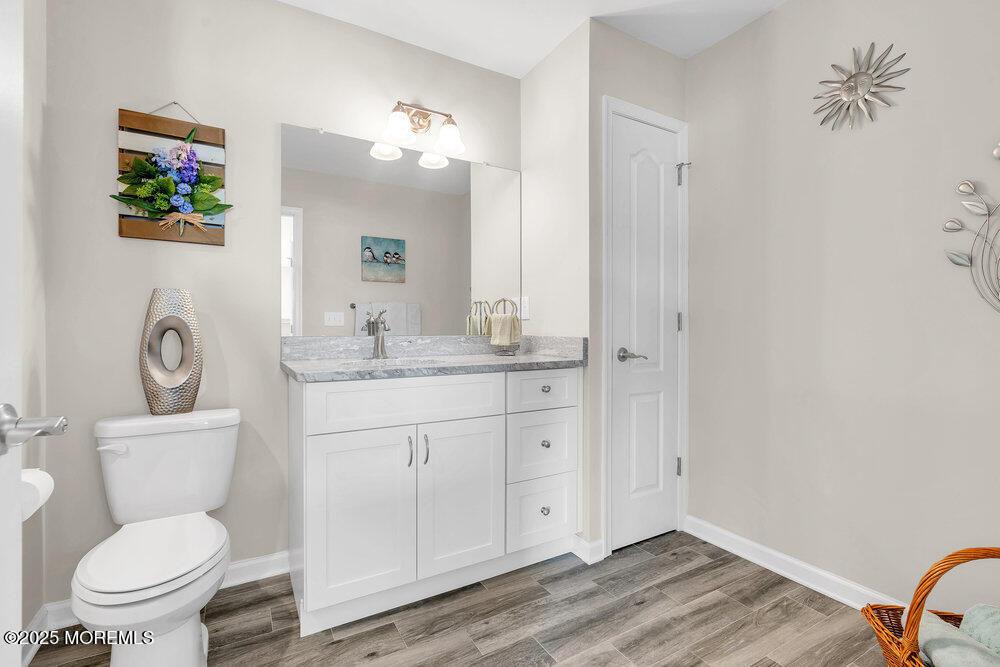 17 Green Tree Circle Hazlet, NJ 07730 - Photo 24 of 29 a bathroom with a granite countertop toilet sink and mirror
