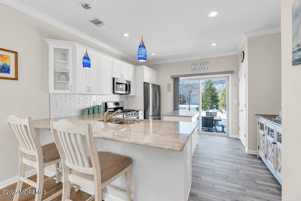 17 Green Tree Circle Hazlet, NJ 07730 - Photo 10 of 29 a kitchen with granite countertop a dining table chairs and chandelier